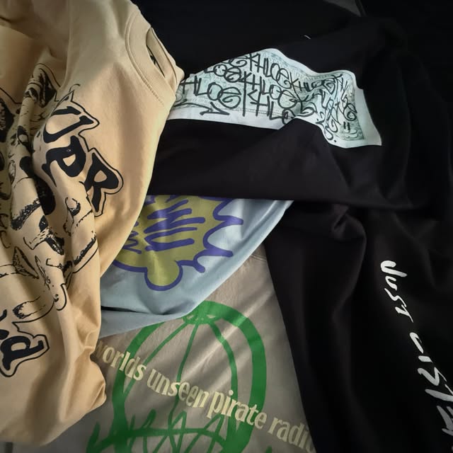 A stack of Worlds Unseen garments
